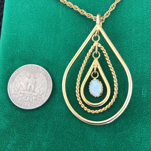 Vintage Opal like free moving oval stone, 3 free moving oval gold colored hoops. - Picture 5 of 9